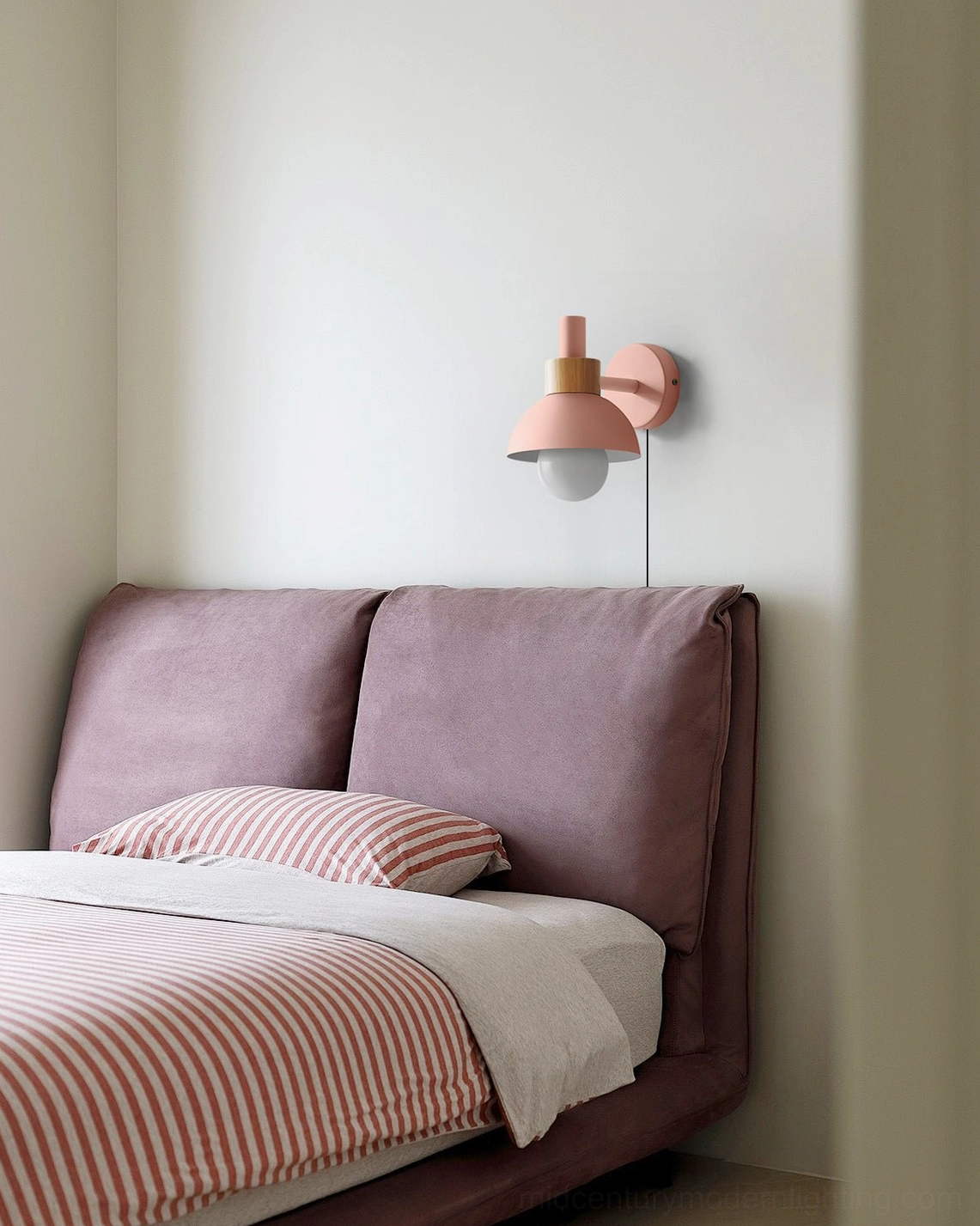 Fanta pink plug-in sconce mounted in minimalist purple bedroom above nightstand
