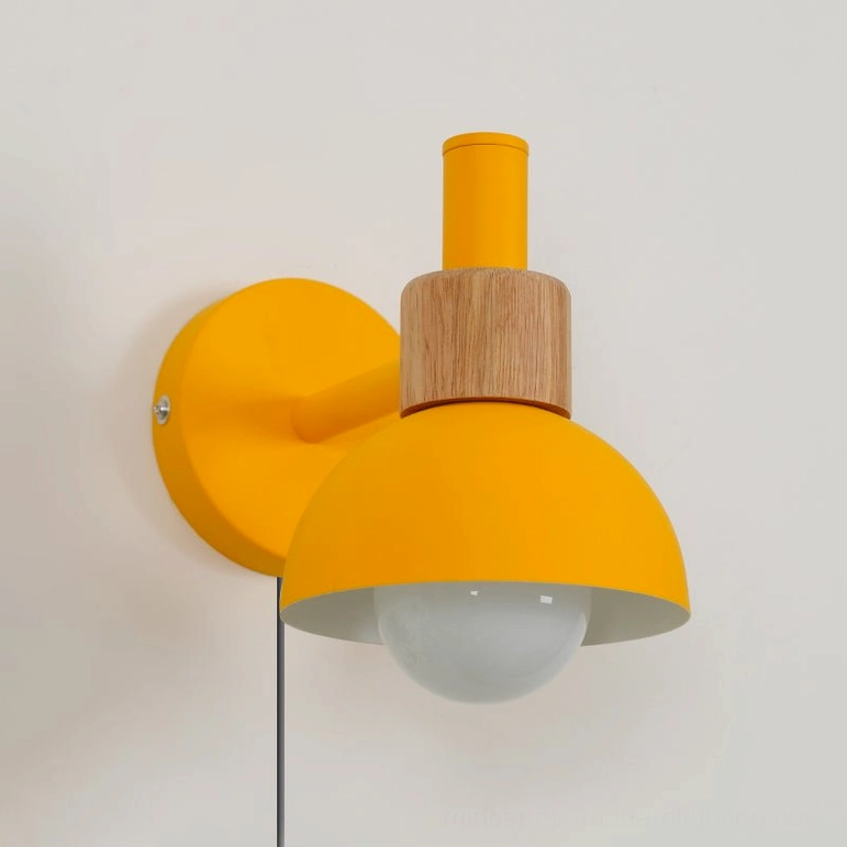 Fanta yellow and natural wood plug-in wall sconce in cheerful modern interior