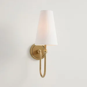 Close-up side view of Farlane wall lamp showing curved brass arm and round backplate