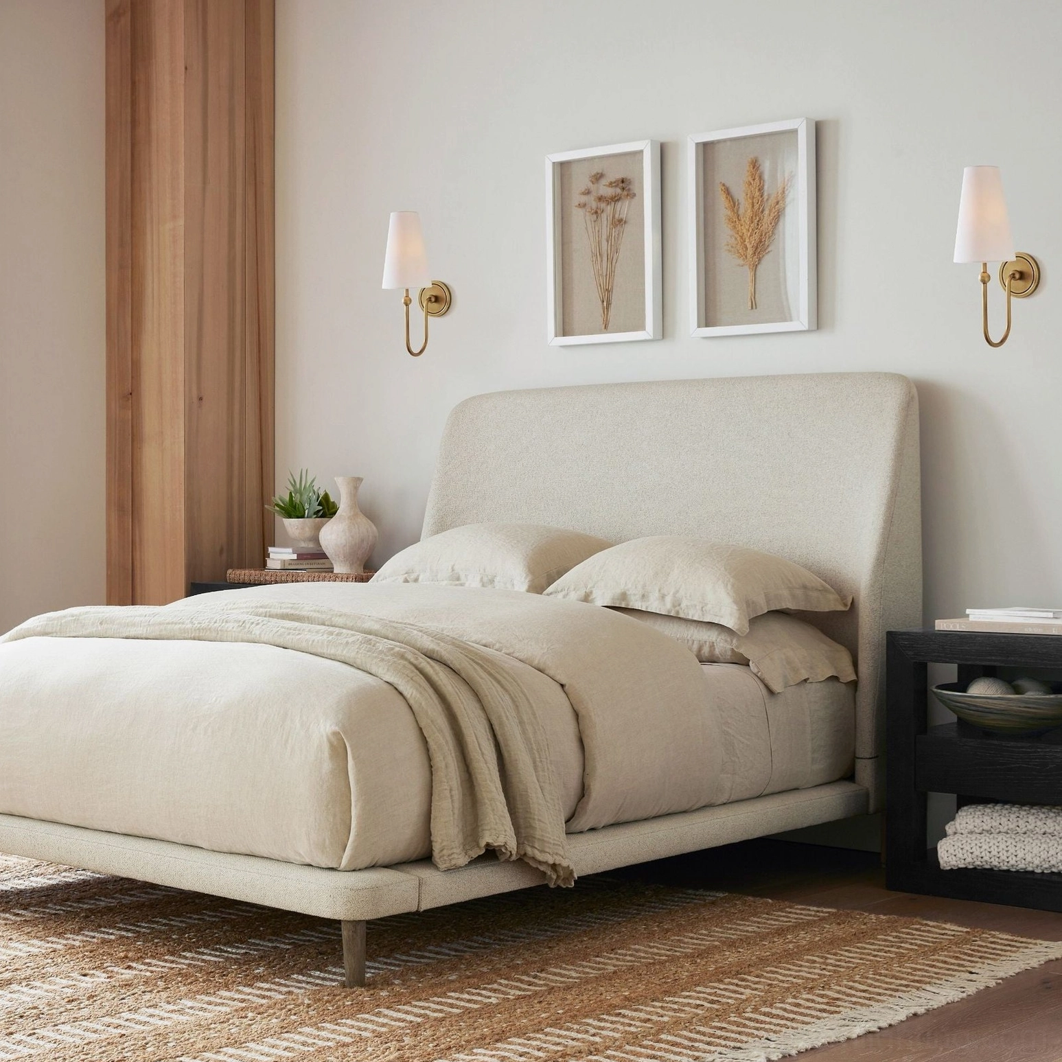 Matching Farlane wall sconces in bedroom creating symmetrical bedside accent lighting