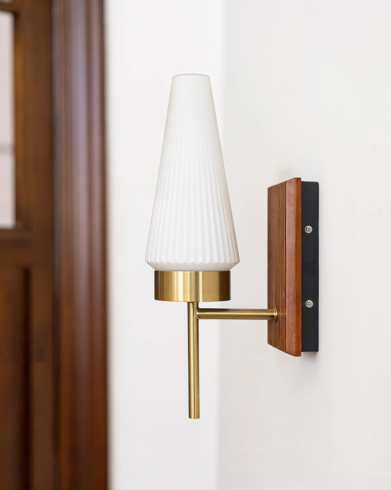 Farrell mid-century sconce three-quarter angle with fluted white glass shade and brass metal arm details