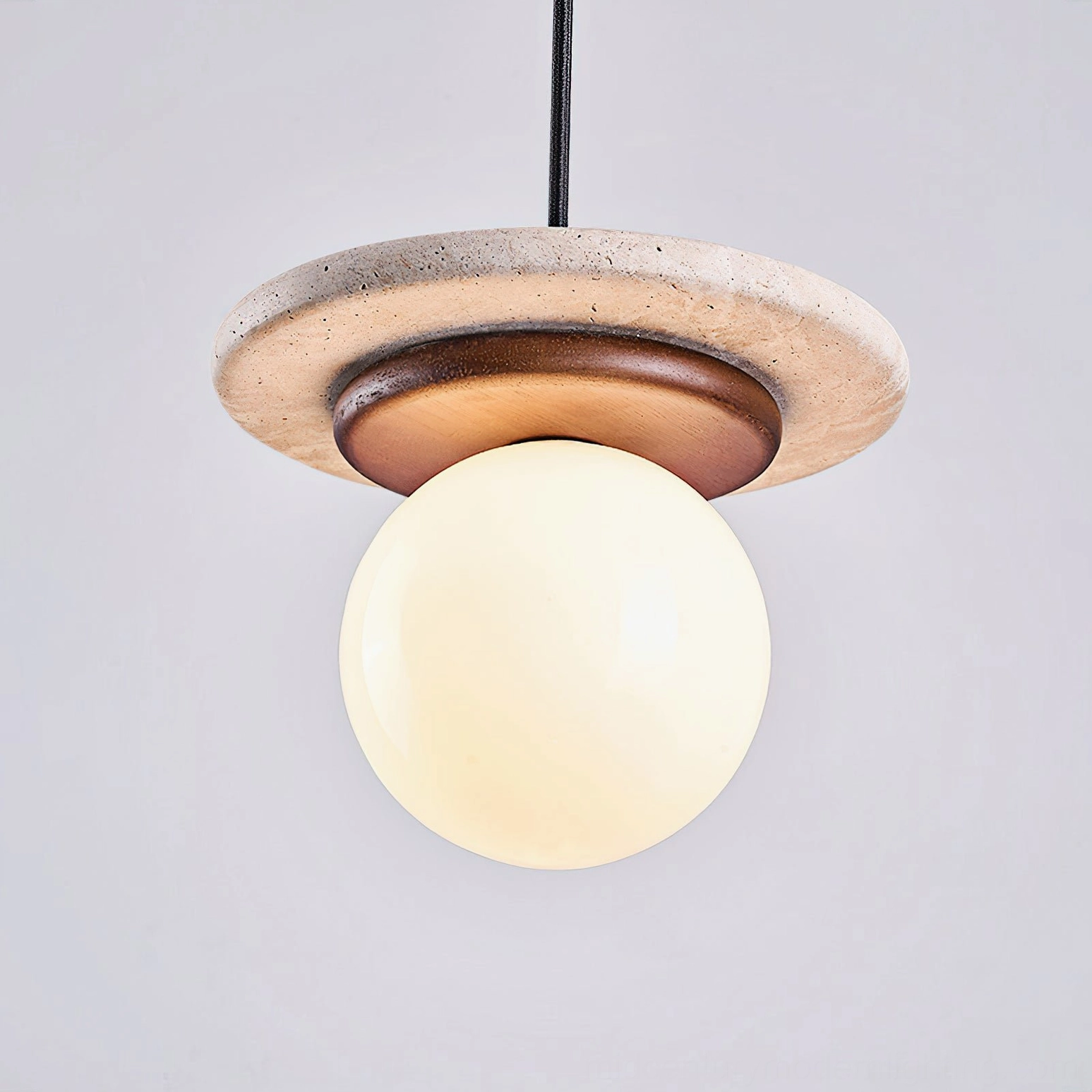 Farren travertine pendant light frosted glass globe with ambient warm glow illumination effect