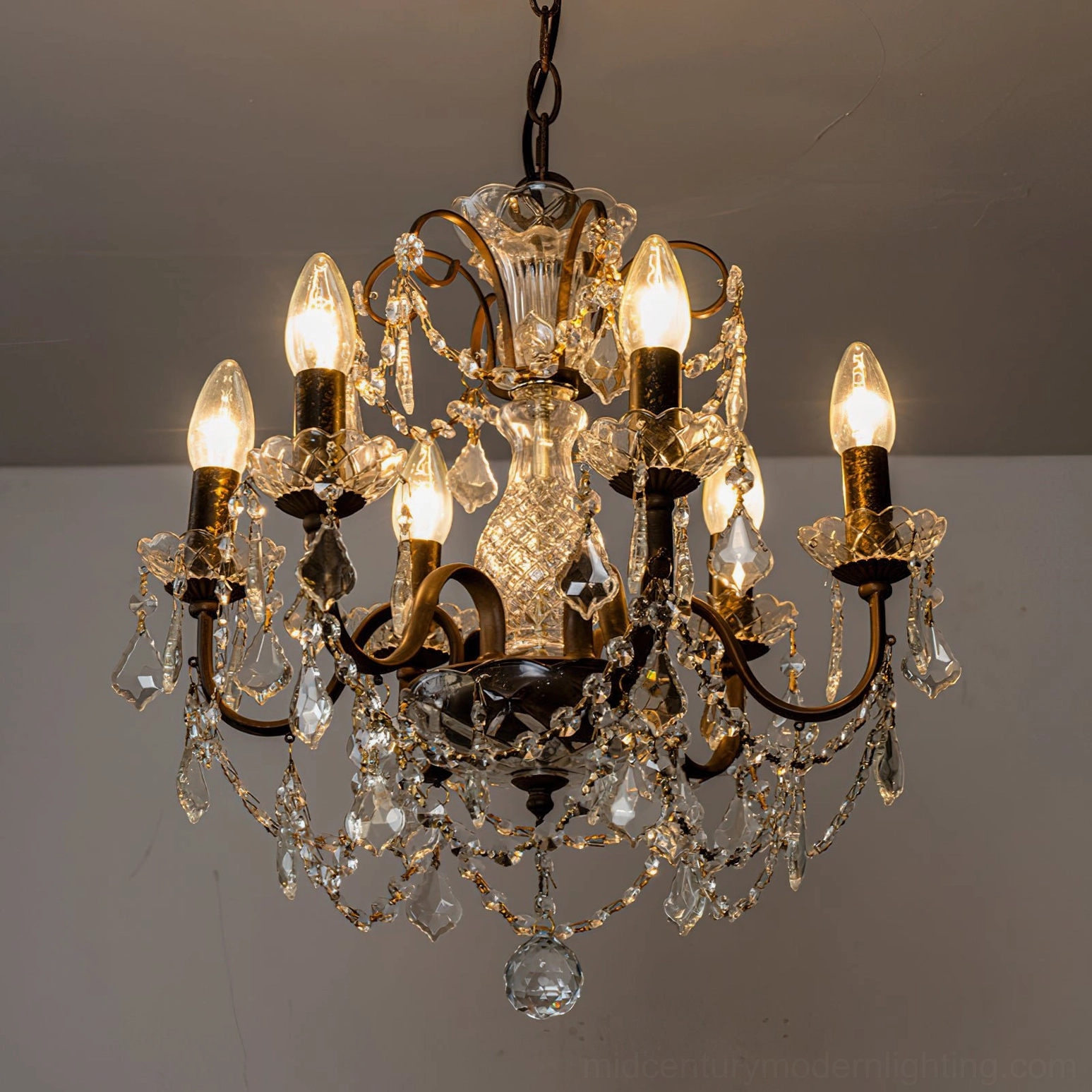 Unlit Fauna crystal chandelier showcasing metal frame geometry and crystal suspension pattern on studio background
