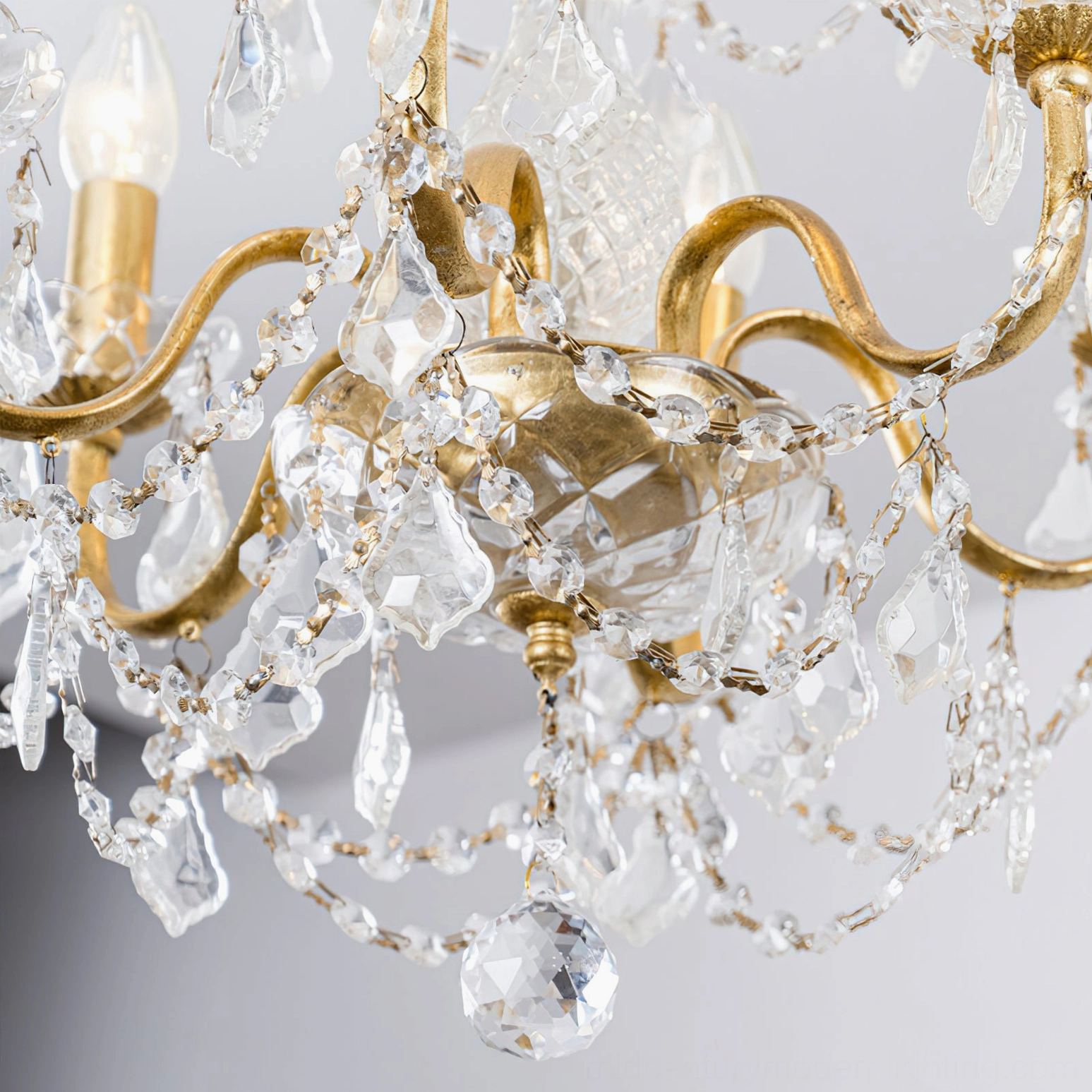 Contemporary room setting featuring lit Fauna crystal chandelier creating sophisticated multi-directional light refraction