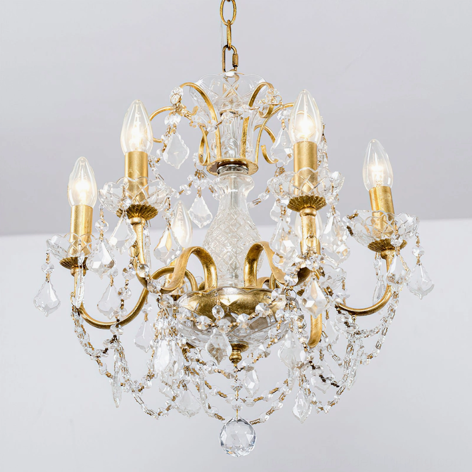 Close-up overhead view of illuminated Fauna crystal chandelier showing intricate crystal clustering and light refraction patterns