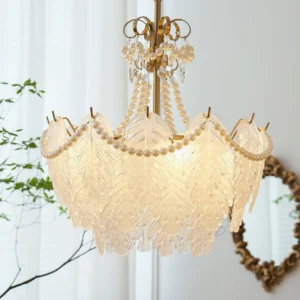 Illuminated Feather Glass Chandelier with warm light glowing through cascading pearl strands and crystal prisms
