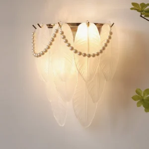 Feather Pearl Wall Sconce - illuminated warm glow, layered feather shades with pearl chain accents, indoor living room display