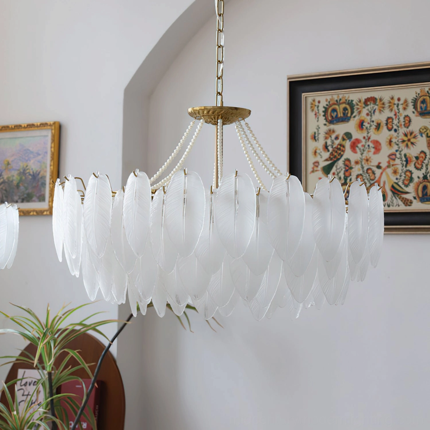 Feathered glass chandelier in bedroom interior demonstrating intimate lighting ambiance with mid-century modern furnishings and minimalist decor