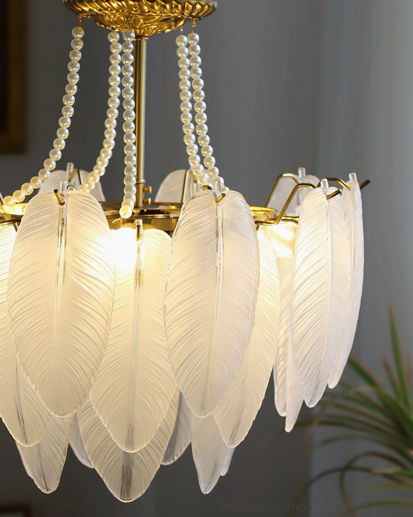 Feathered glass chandelier in Scandinavian-inspired interior with natural wood tones, organic textiles, and minimalist furnishings