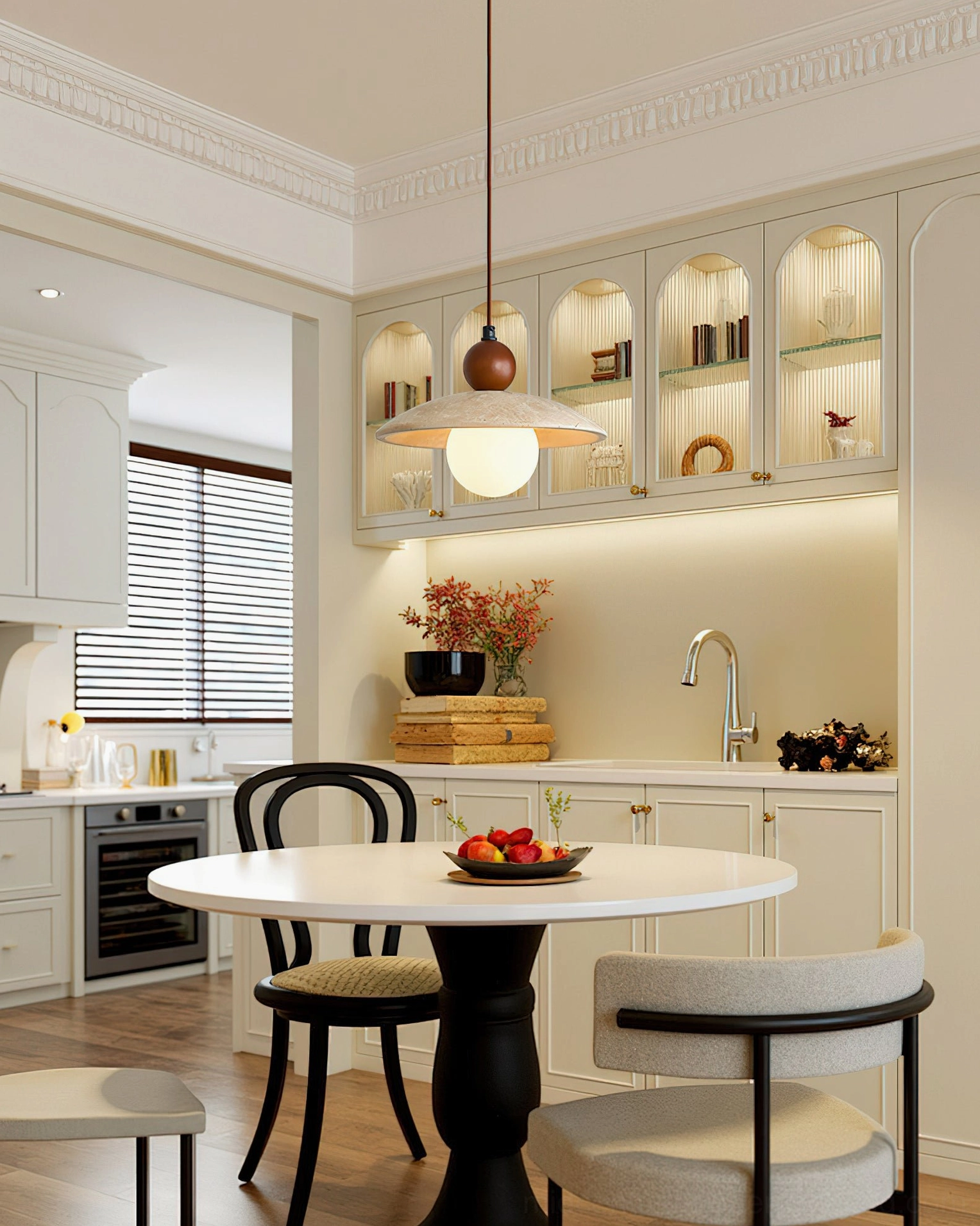 Ferox pendant light suspended above round dining table in French retro kitchen-dining area