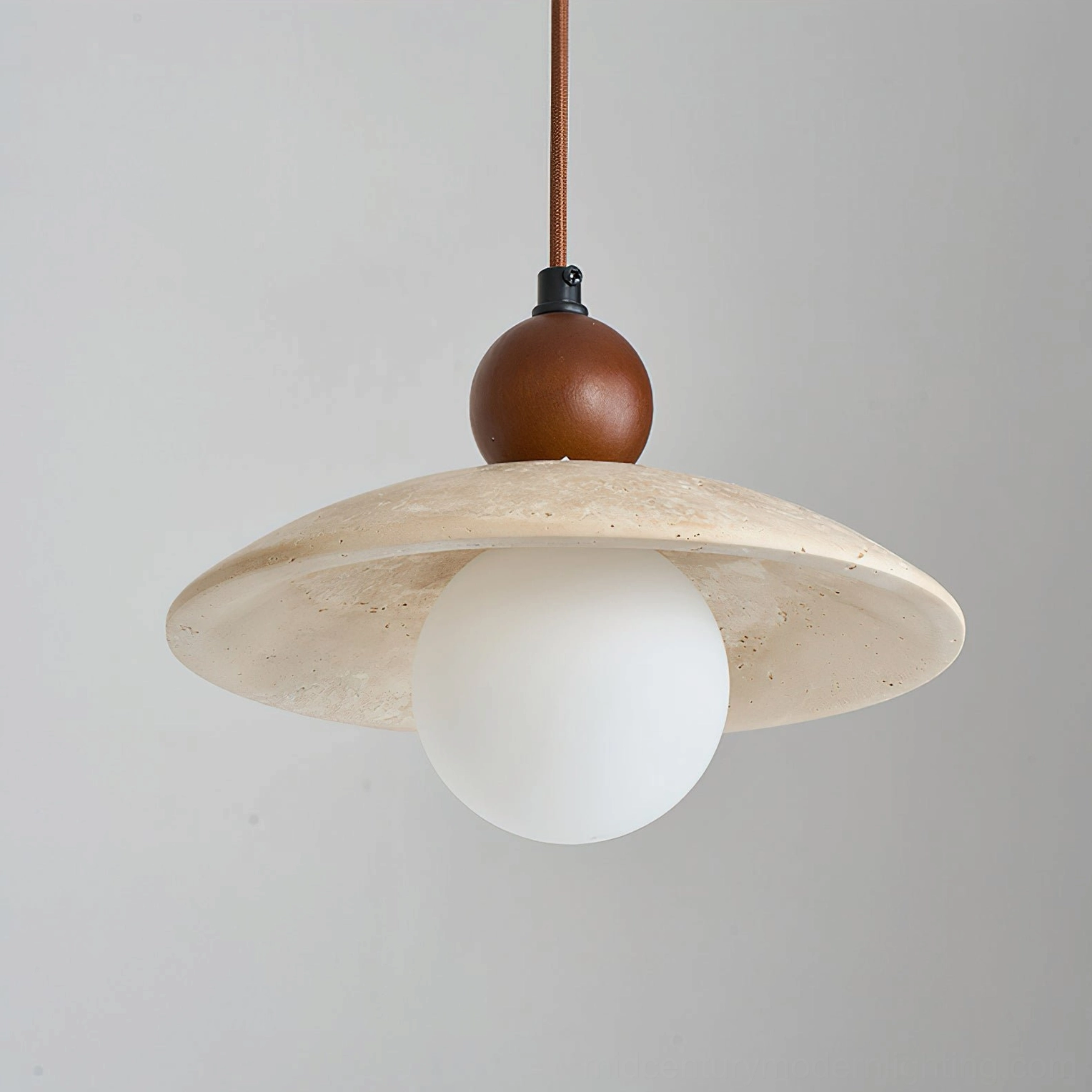Ferox travertine pendant light full product view showing shade, frosted bulb, and hardware from bottom angle, studio photography