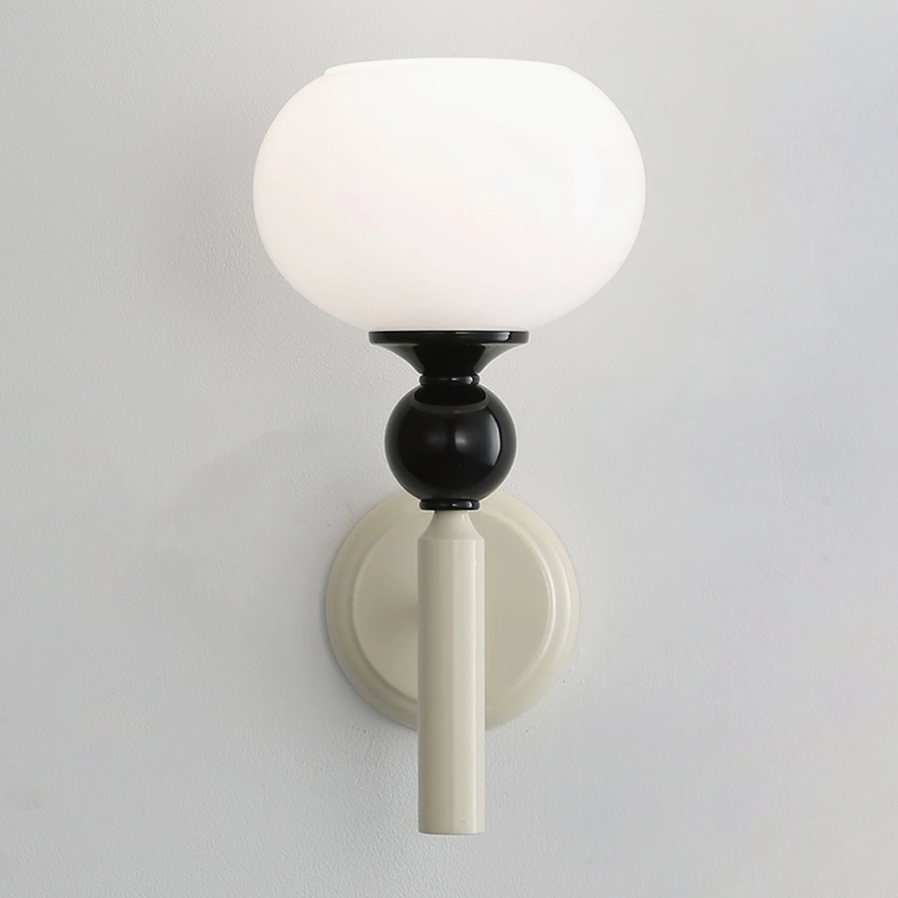 Feya globe wall lamp close-up detail of opal frosted glass shade and mounting bracket