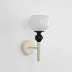 Feya wall sconce three-quarter side angle showing smooth matte metal hardware and spherical design