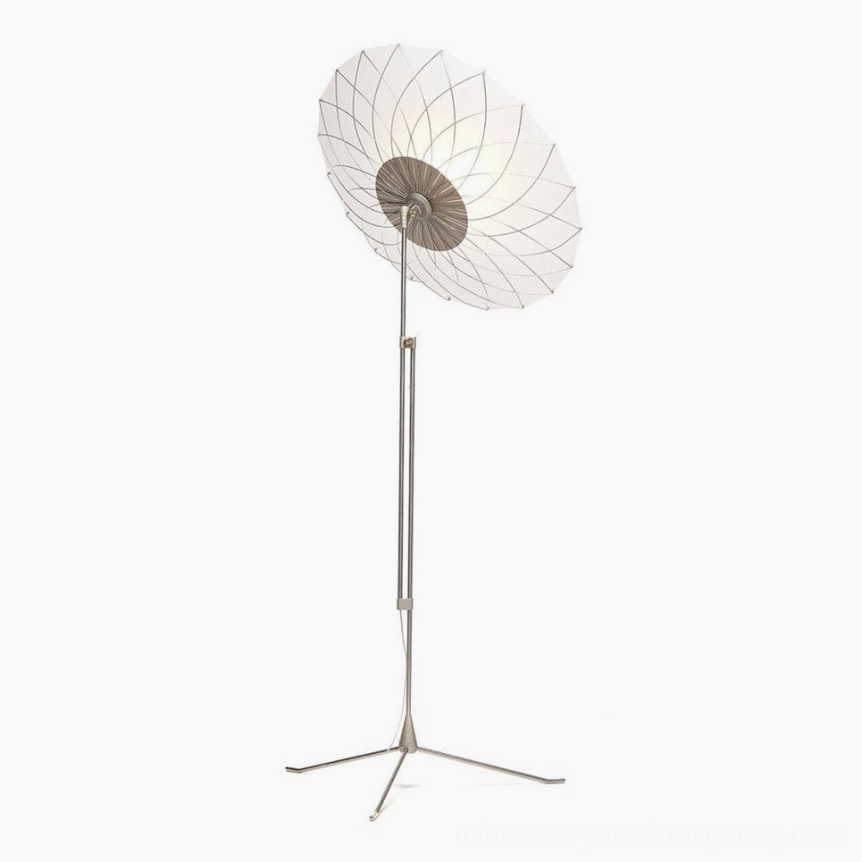 Side angle view of filigree floor lamp showing tripod base, metal framework, and vertical pole structure
