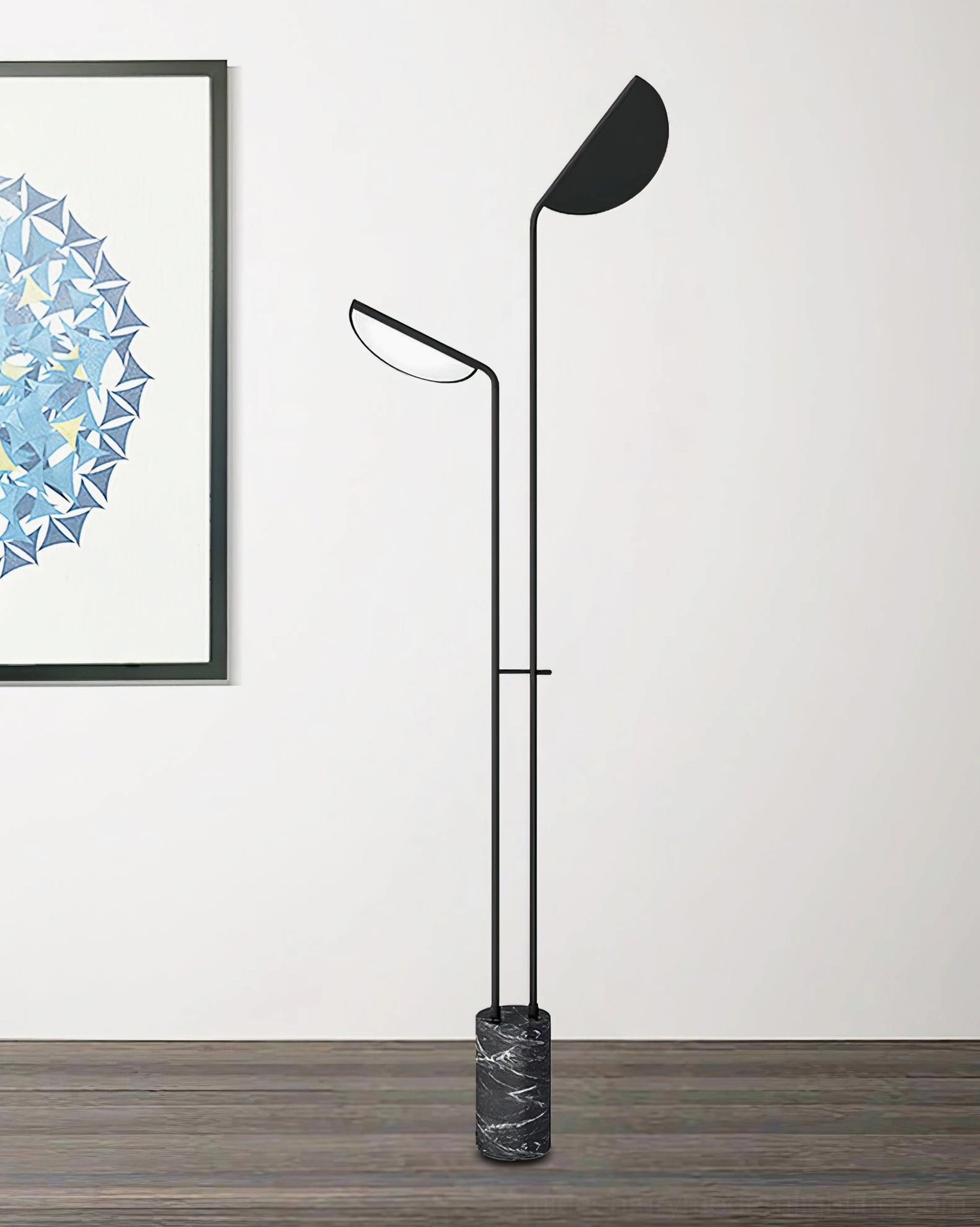 Two black Filo floor lamps with marble bases in studio setting on wood floor with wall art - frontal architectural view
