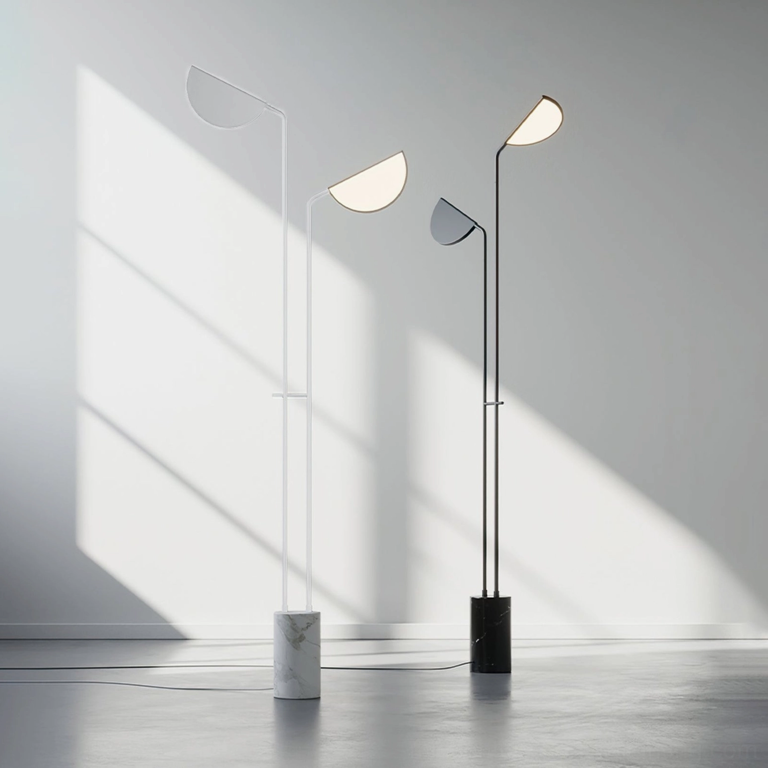 Pair of Filo floor lamps in white and black finishes in sunlit contemporary interior space - three-quarter view showing minimalist design