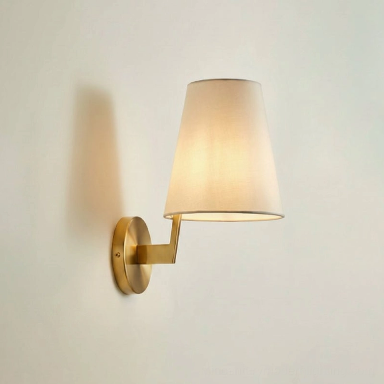 Finley wall sconce brass gold finish with warm illumination, side profile showing elegant proportions