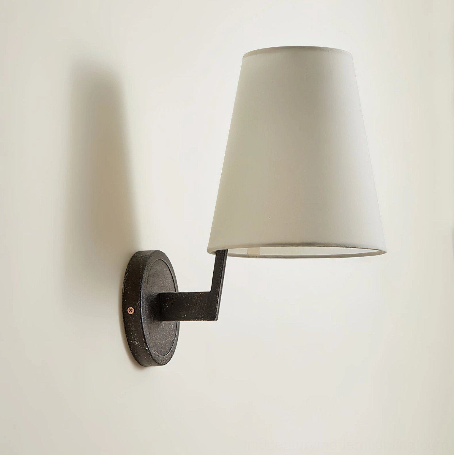 Finley mid-century modern wall sconce architectural styling, warm light diffusion through tapered fabric