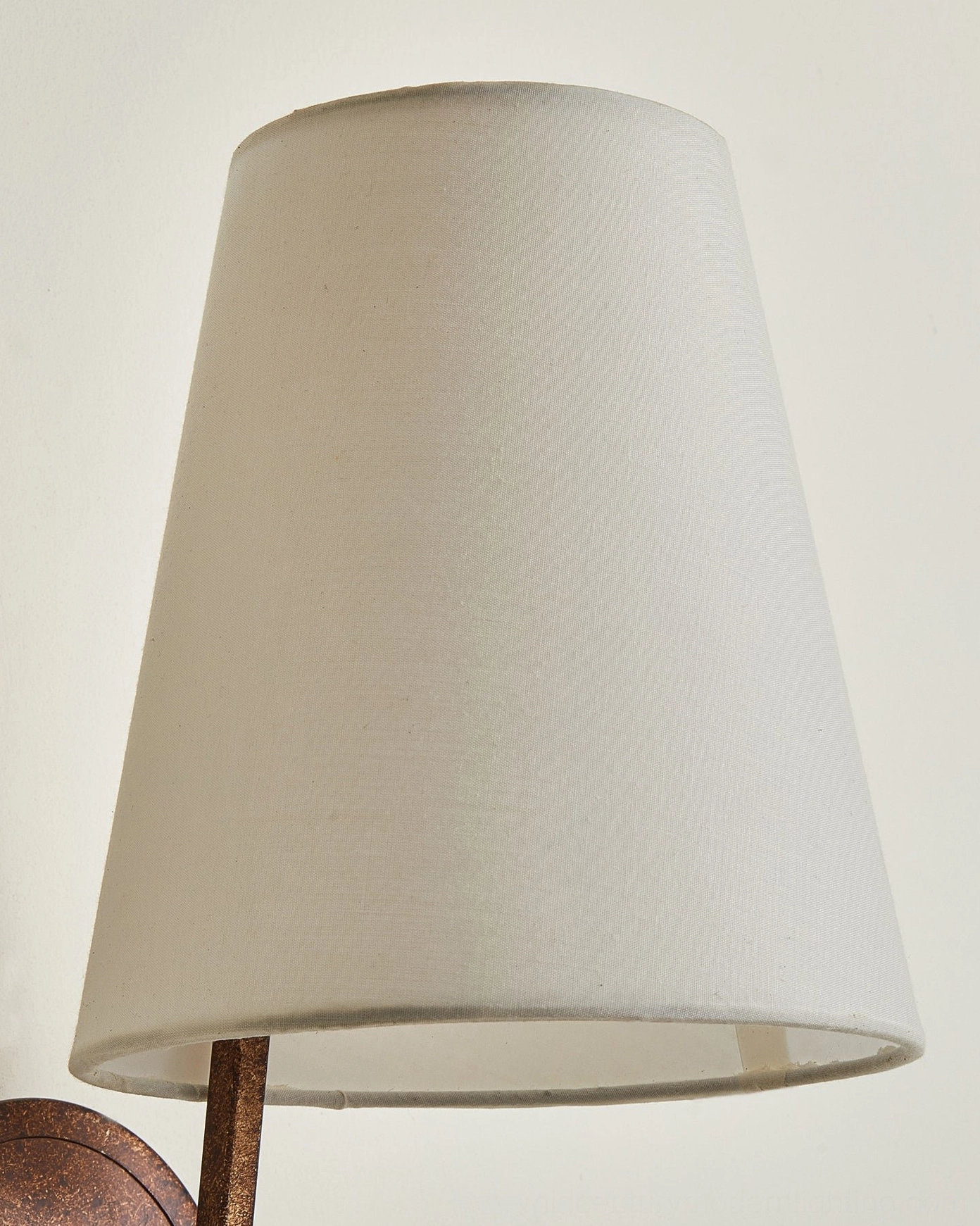 Finley wall lamp antique bronze metal bracket detail, close-up side view showing mount hardware