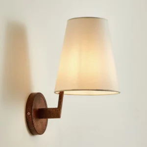 Finley wall sconce front view showing antique bronze metal base and unlit off-white fabric shade against neutral wall
