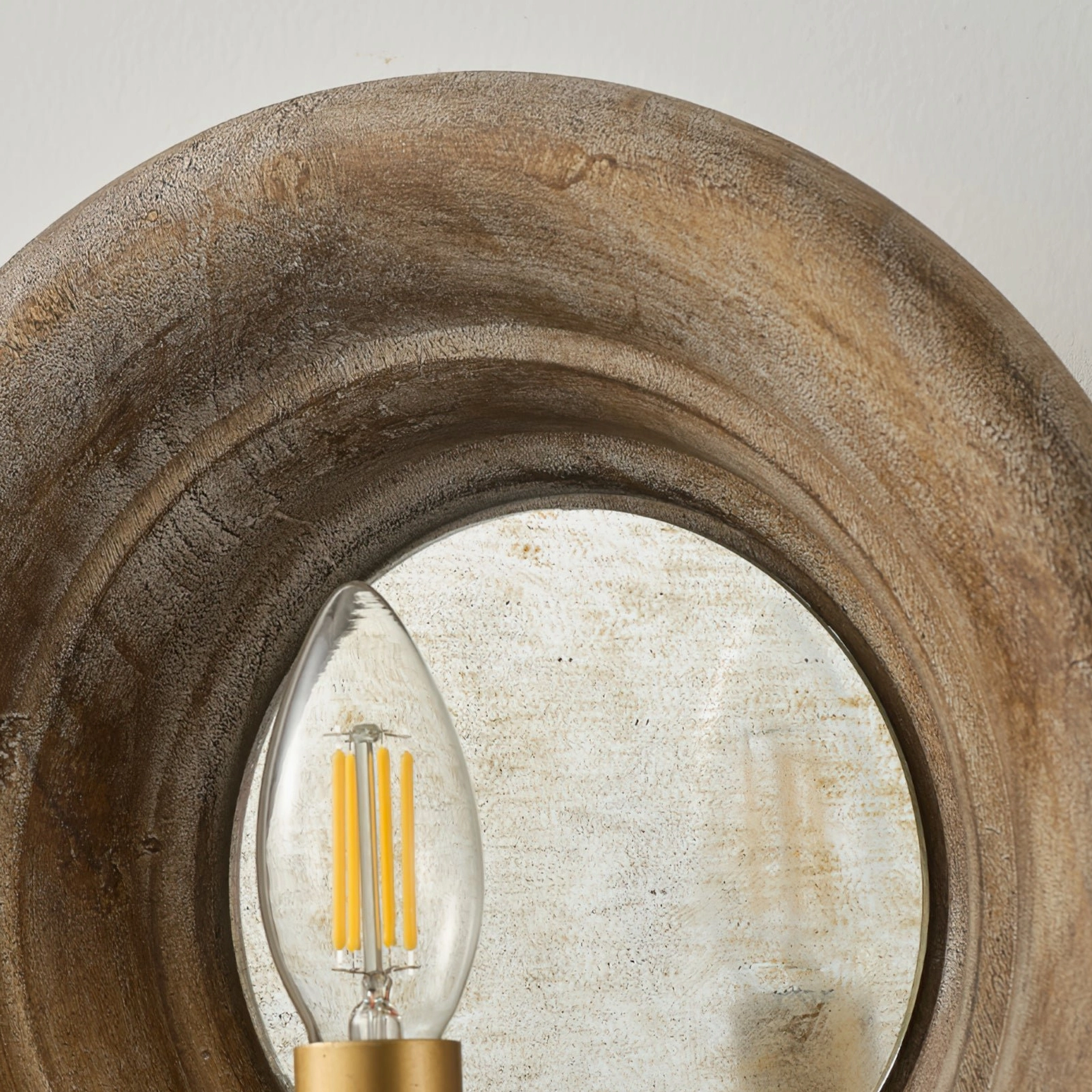 Extreme close-up of Finn distressed circular mirror and weathered wood texture detail