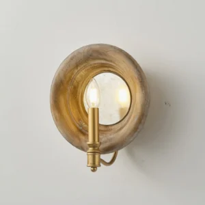 Close-up detail of Finn vintage wall lamp showing lit candle bulb and reflective round mirror center