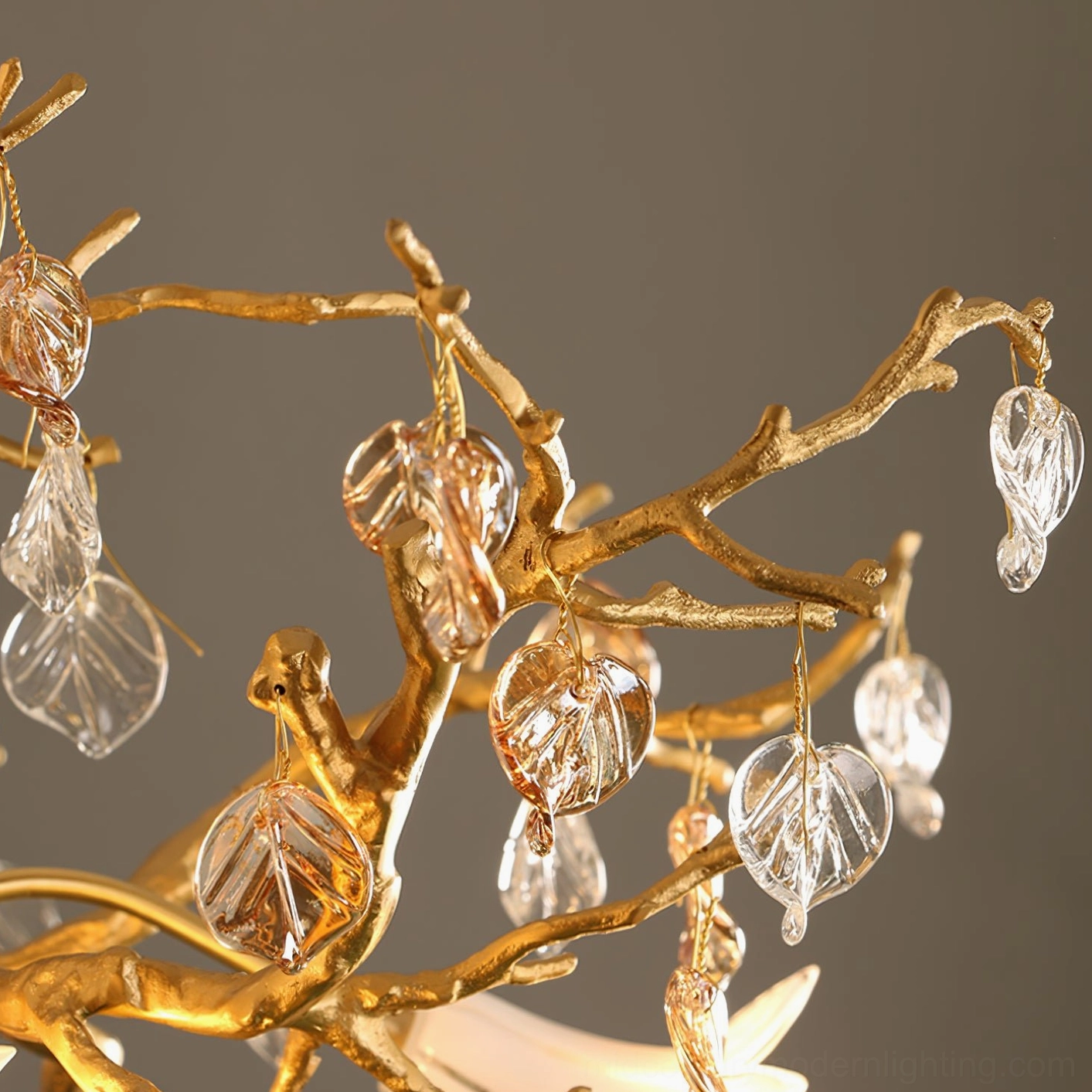 Fiori chandelier detail showing twisted brass branches, crystal ornaments, and bird sculpture close-up