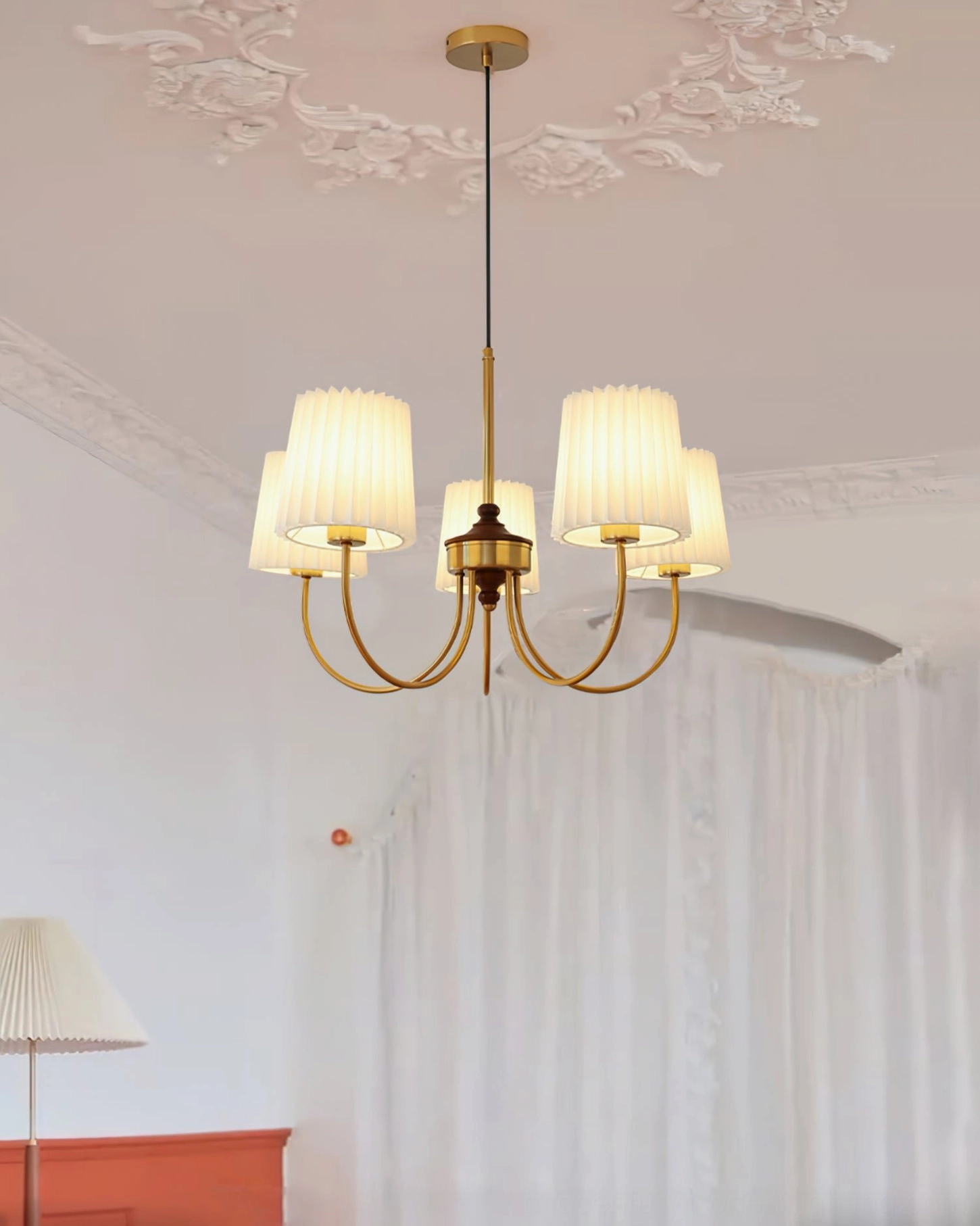 Illuminated 5-head fabric shade chandelier in elegant bedroom with sheer curtains
