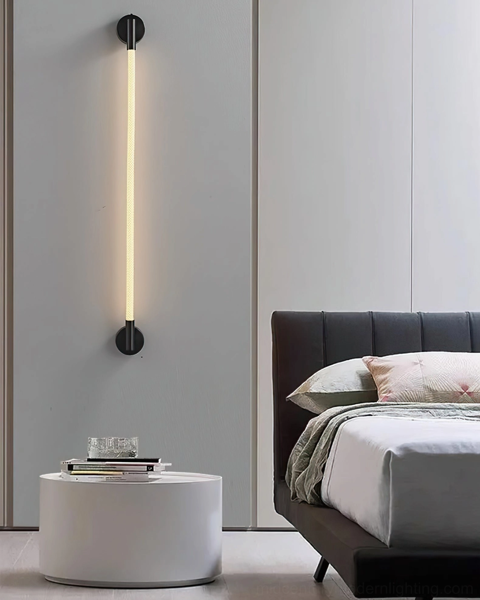 Flecto Tube wall lamp mounting bracket and connection detail showing brushed metal hardware quality