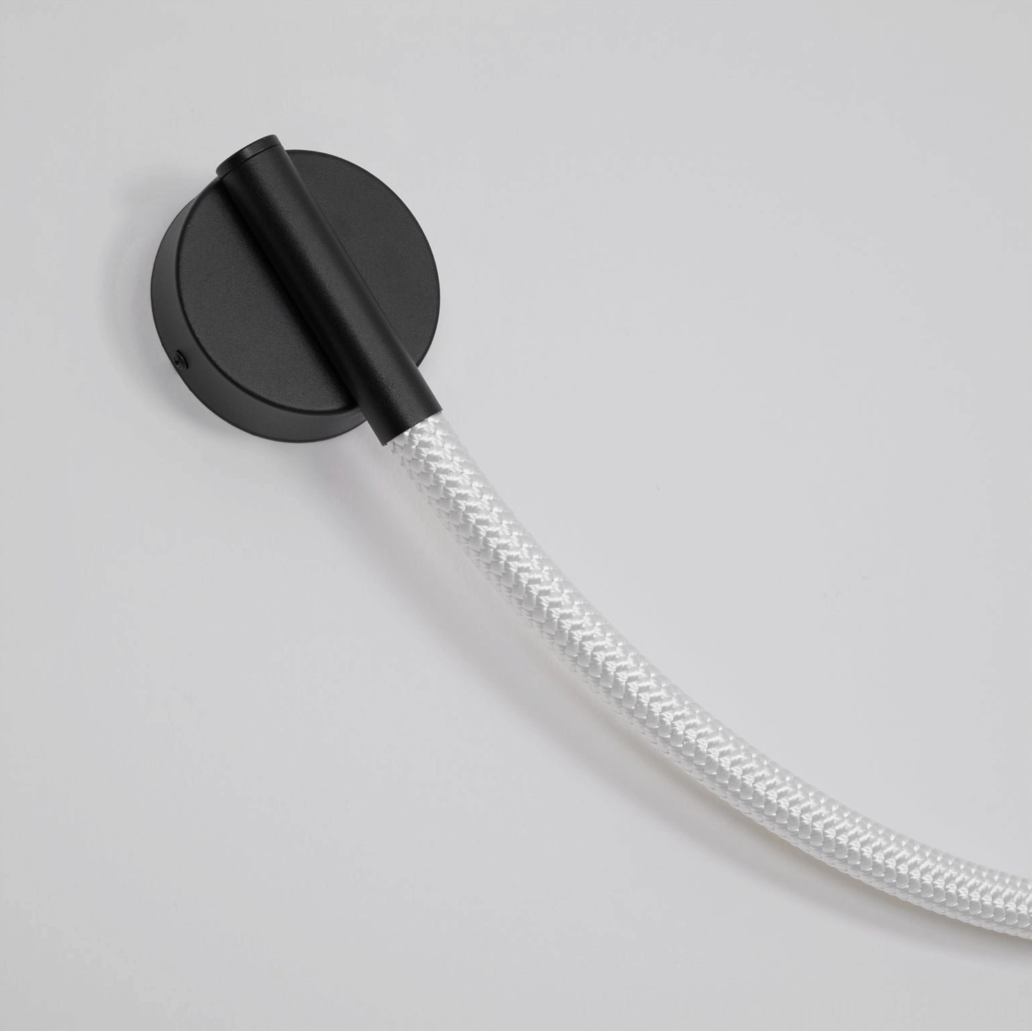 Flecto Tube wall lamp construction detail showing woven fiber layer and metal hardware assembly