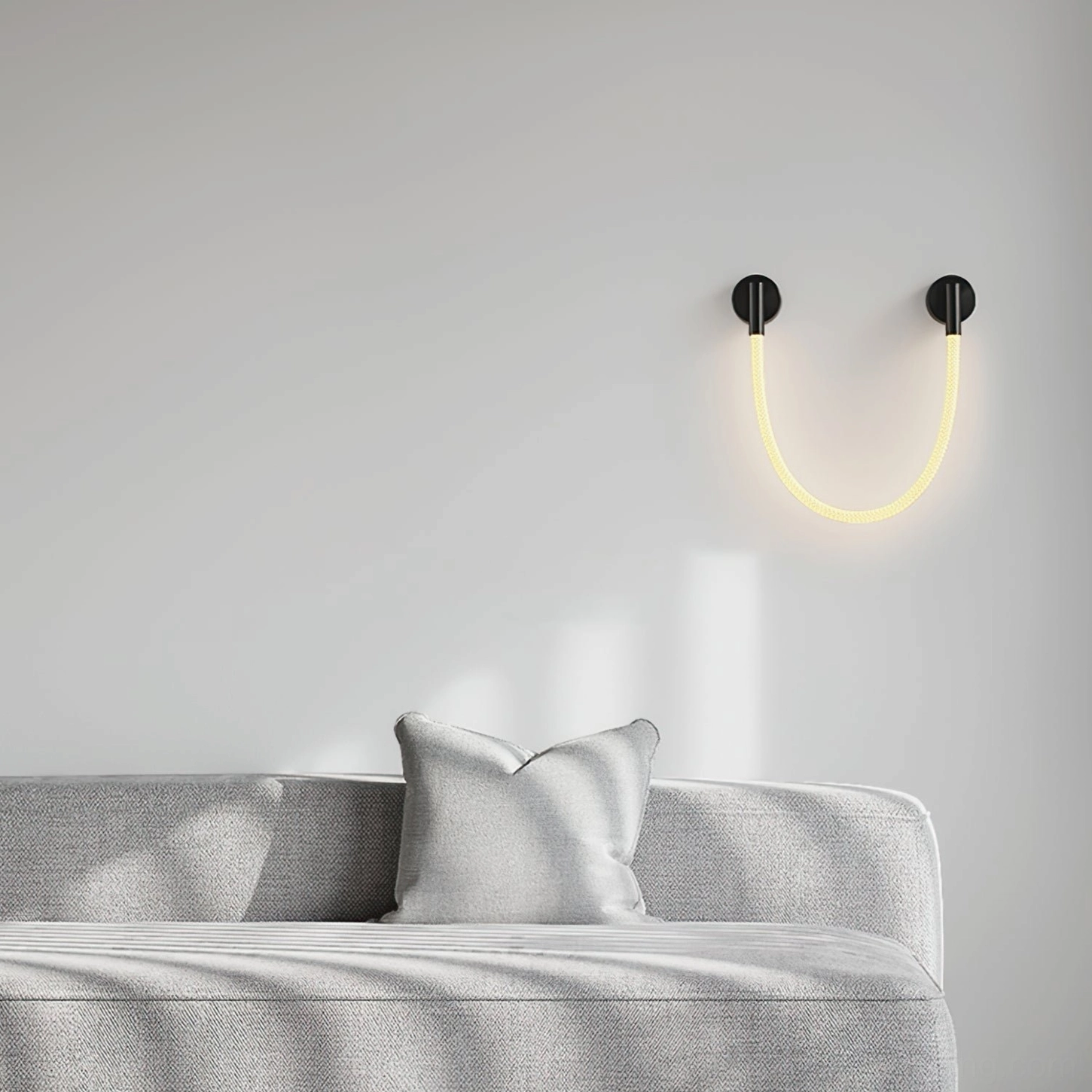 U-shaped Flecto Tube LED wall lamp in living room providing warm ambient lighting above modern sofa, minimalist interior setting