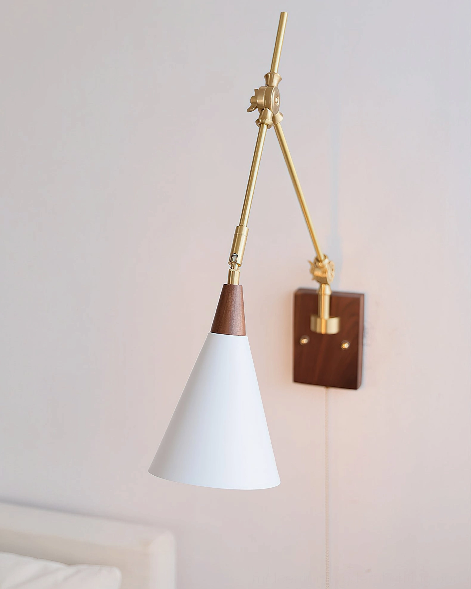 Fleka wall lamp mounted on bedroom wall showing reversed arm orientation and pull cord switch detail
