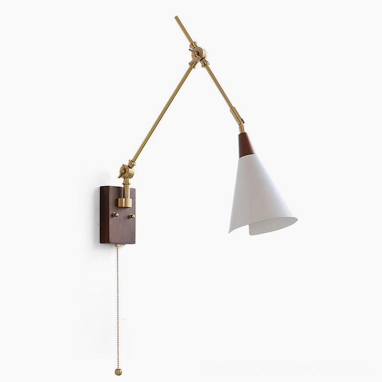 Fleka swing arm wall lamp angled front view displaying brass articulated arms, walnut wall mount, white conical shade, and pull cord switch