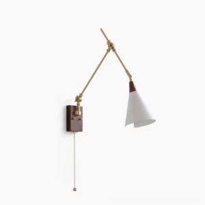 Fleka swing arm wall lamp studio view featuring brass articulated arms, walnut mounting plate, and white conical shade against white backdrop