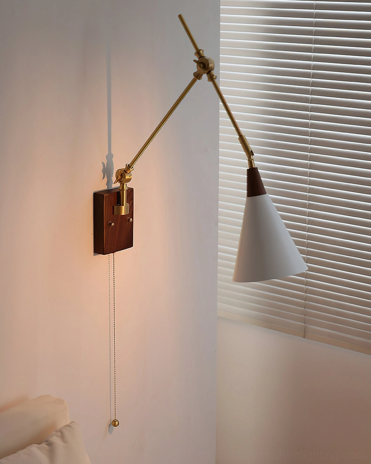 Rear view of Fleka swing arm wall sconce showing mounting hardware, brass articulation joints, and walnut backing plate