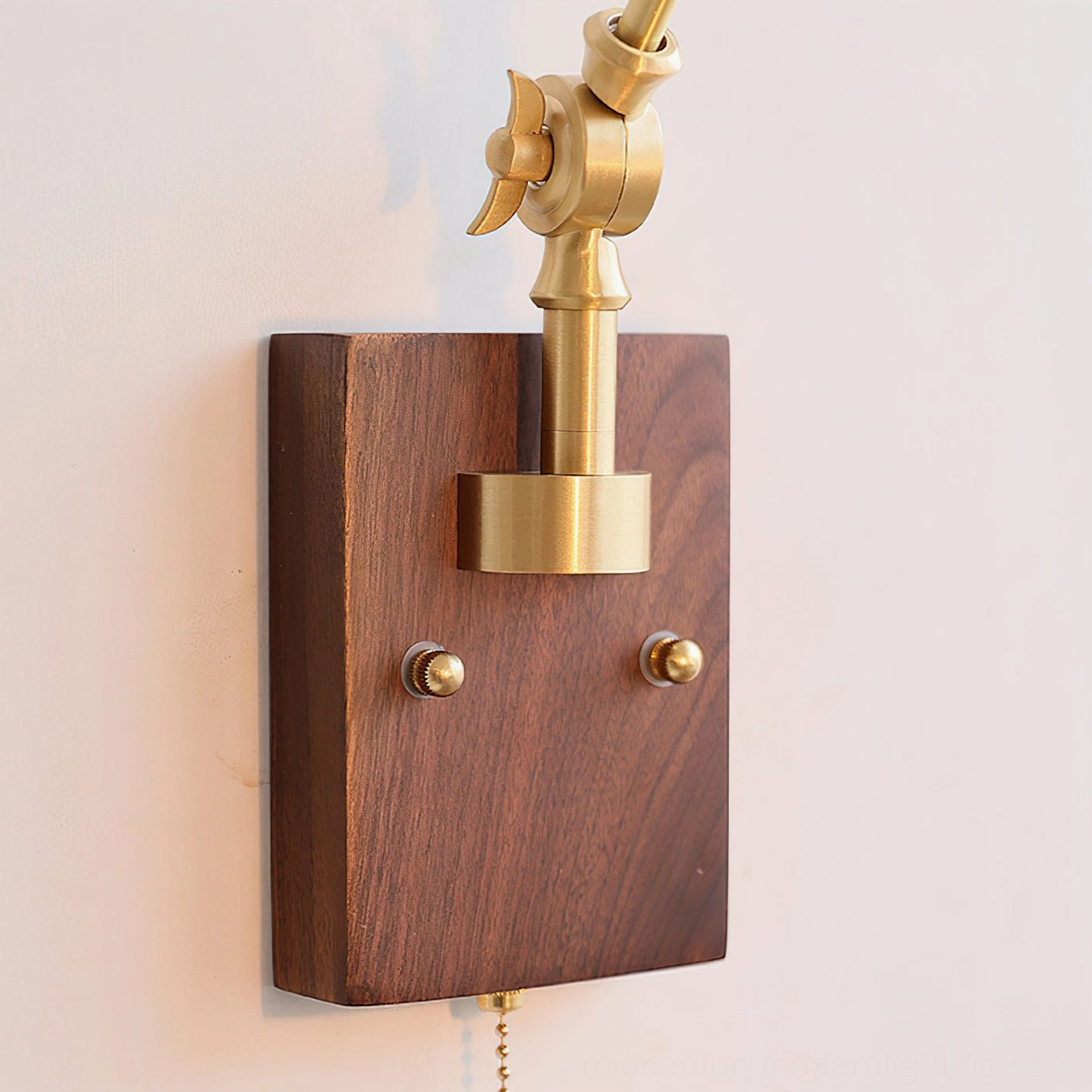 Close-up of Fleka wall lamp mounting assembly featuring walnut wood backing plate, brass adjustable joint, and installation hardware