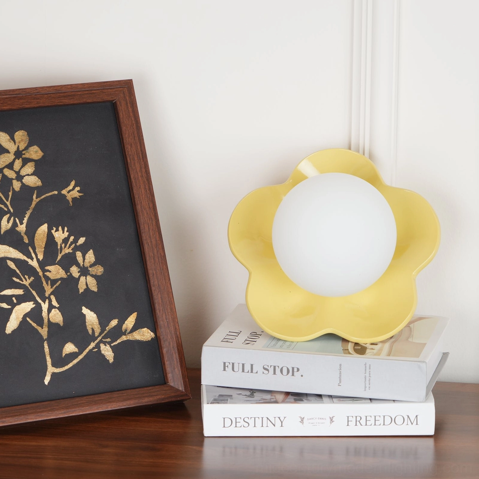 Modern La Fleur wall lamp in yellow finish displayed on wooden furniture with curated decor