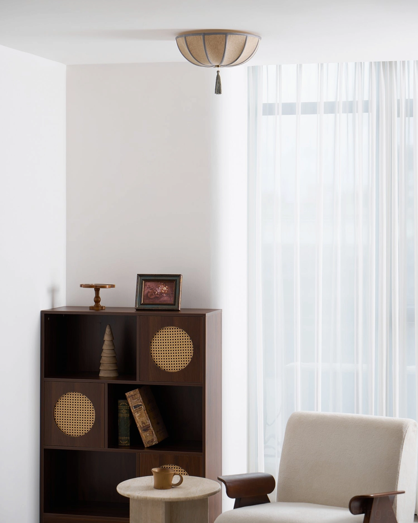 Fleur vintage ceiling light in small living corner with sheer curtains and boho storage cabinet