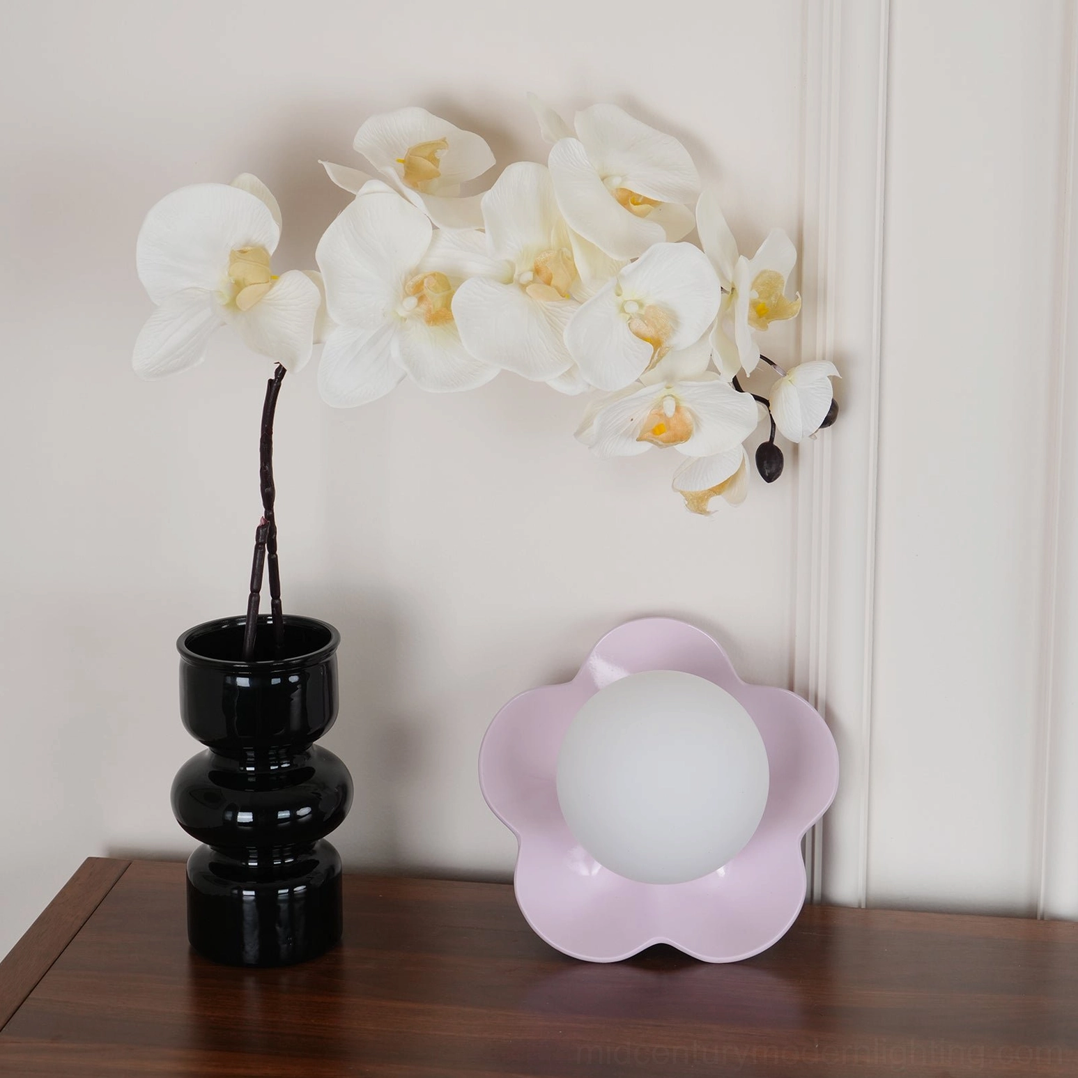 Soft pink-purple pastel flower wall lamp at three-quarter view with black vase styling