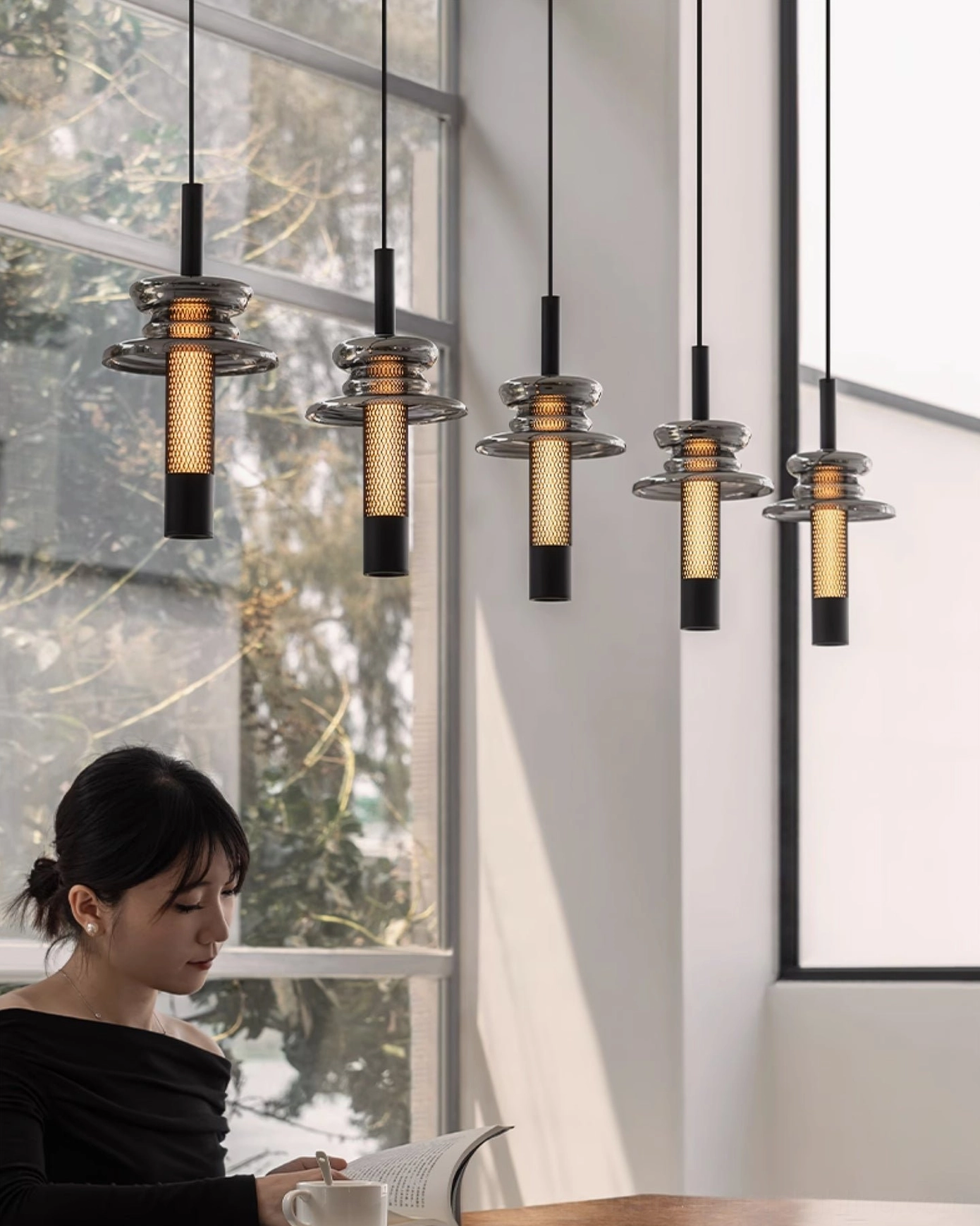Float pendant light in bedroom bedside zone casting warm ambient light on dark wood feature wall
