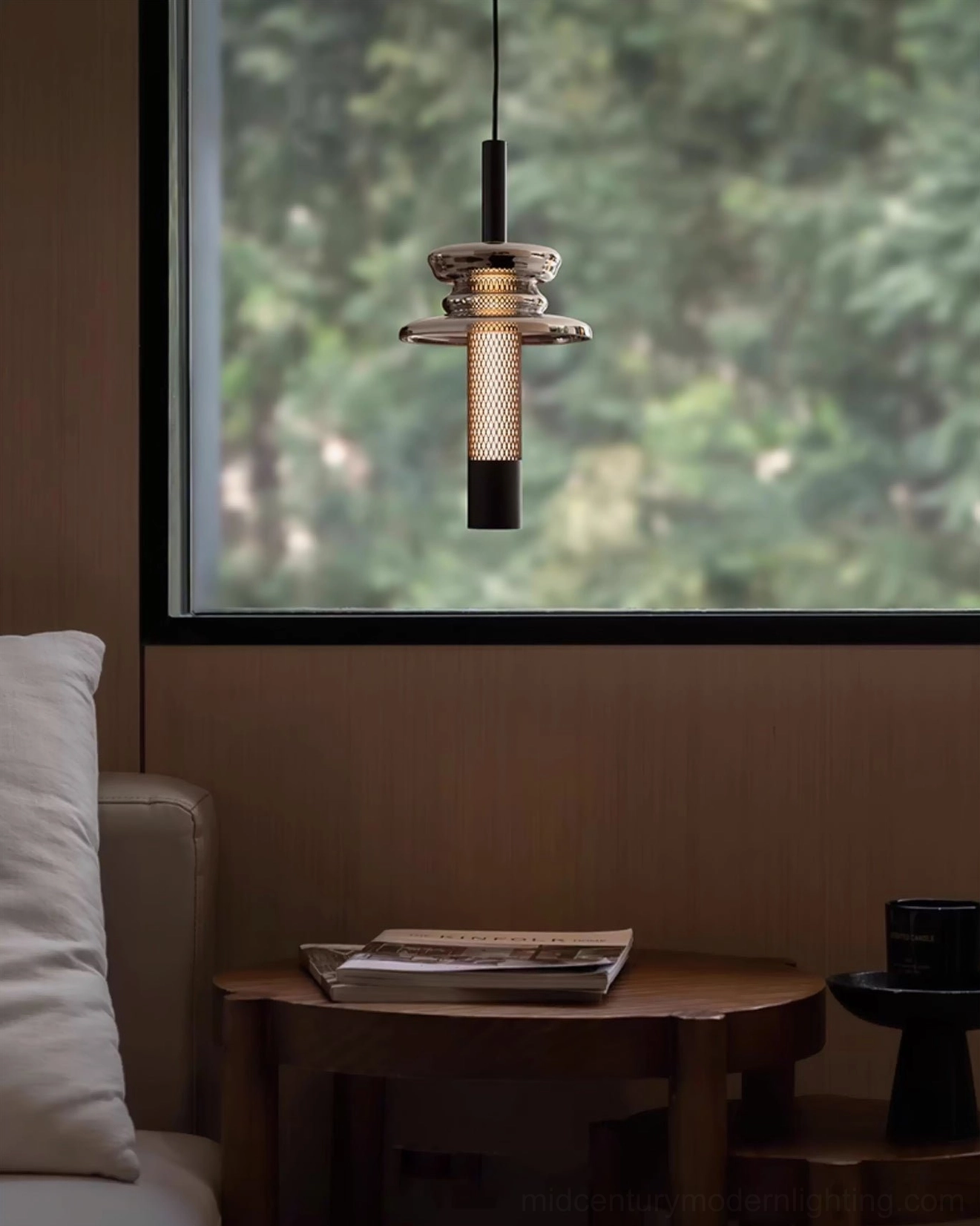 Single float pendant light close-up side angle showing layered glass and metal mesh detail in cozy living room