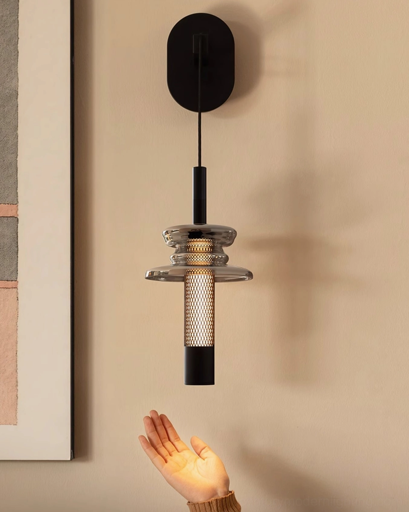 Float industrial wall light fixture detail showing perforated metal mesh and smoked glass construction