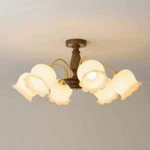 Close-up of vintage flower ceiling chandelier with illuminated cream glass shades, detailed brass hardware, warm glowing aesthetic