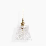 Floral embossed glass pendant lamp with brass hardware, studio view showing detailed 3D rose patterns on clear glass shade