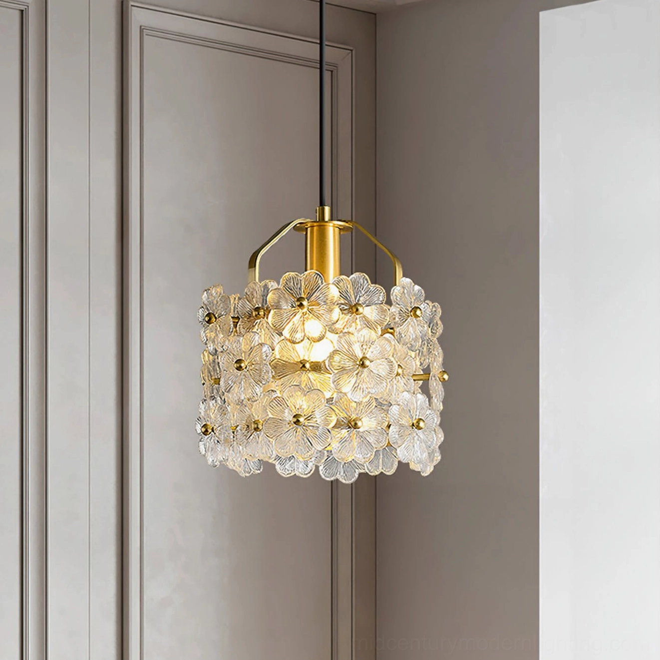 Modern floral glass pendant lamp hanging against minimalist gray wall with downward lighting angle