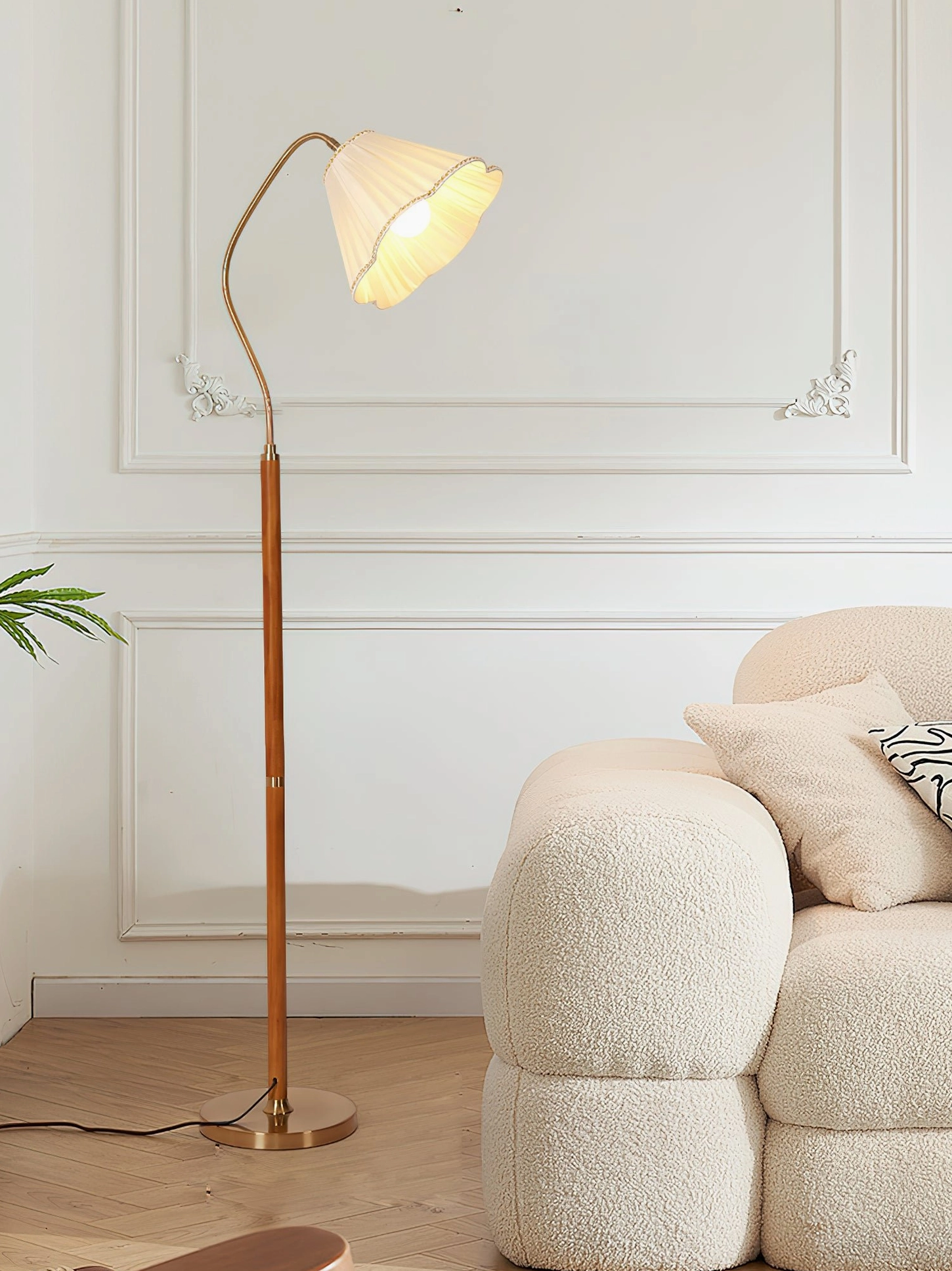 Florentine adjustable floor lamp in minimalist French living room with white sofa and decorative wall panels