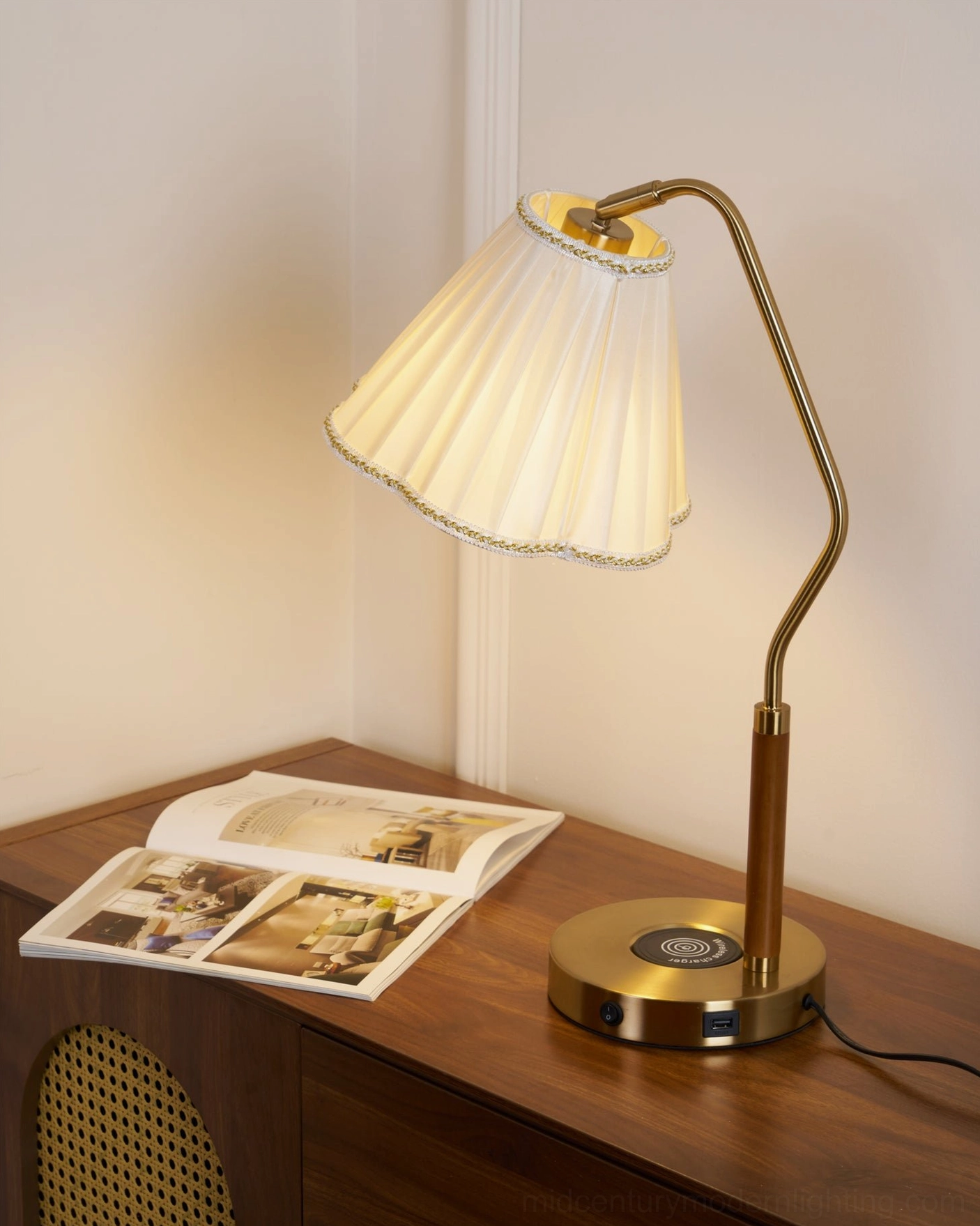 Florentine lamp on dark wood bedside desk with wireless charging port visible