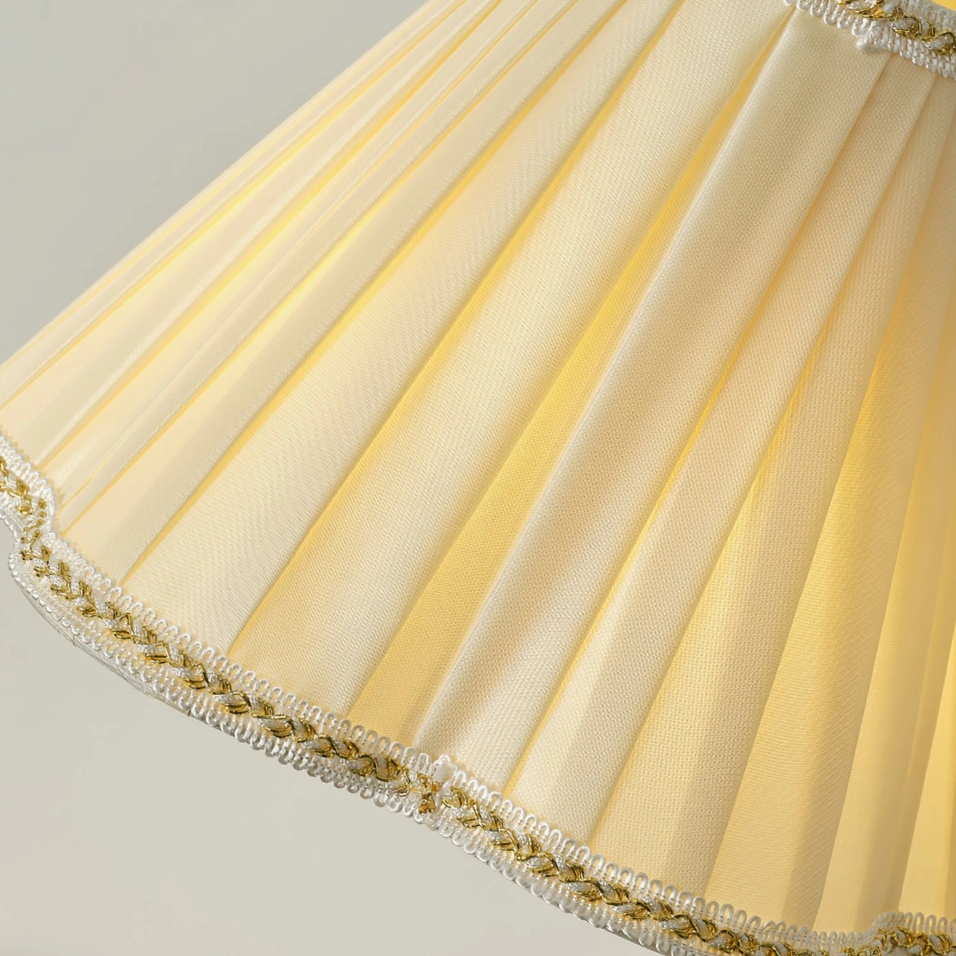Close-up detail of Florentine pleated fabric shade with embroidered trim