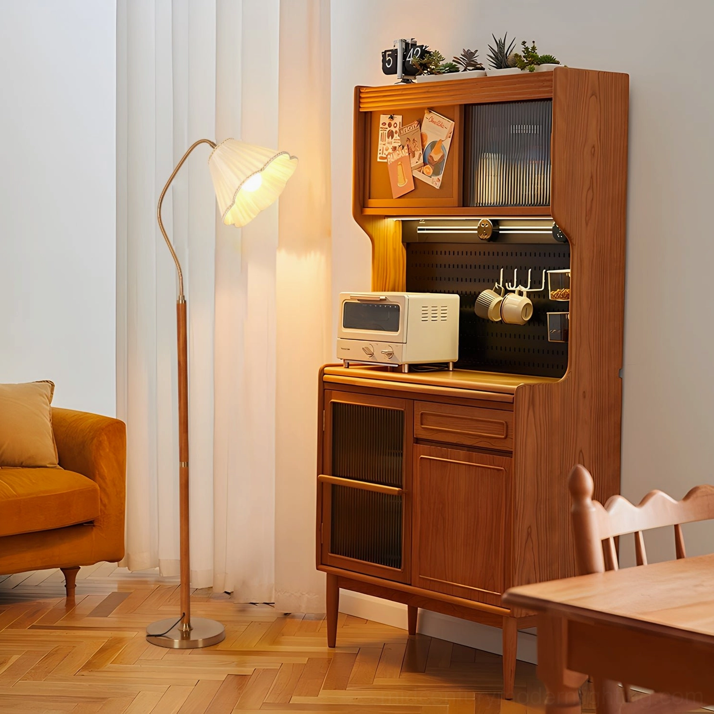 Florentine gooseneck lamp illuminated in dining room with herringbone wood flooring and mid-century furniture