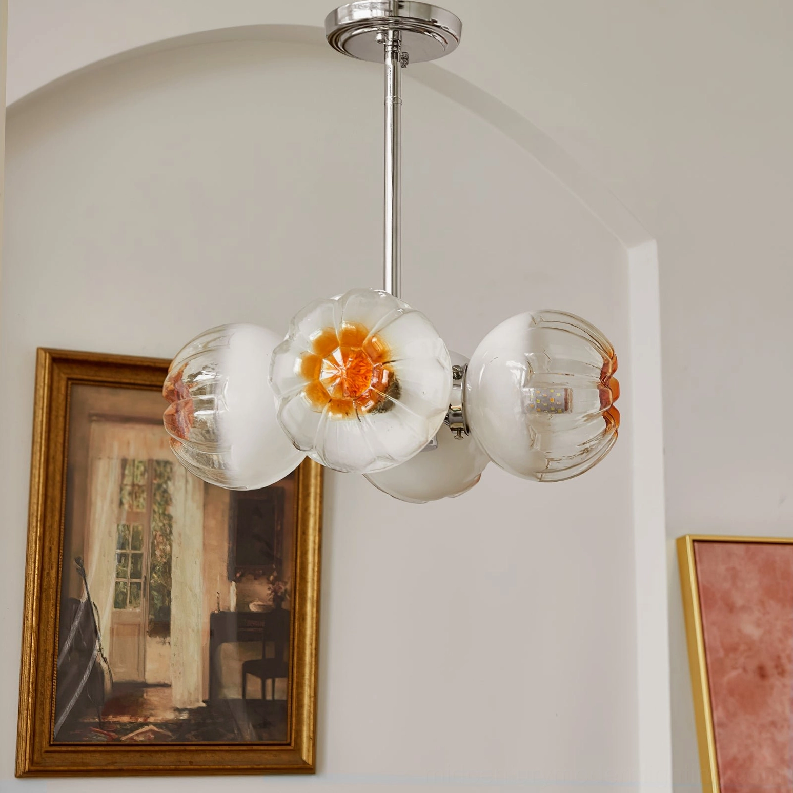 Flower Bud Chandelier with three amber glass petal shades creating warm ambiance in dining environment